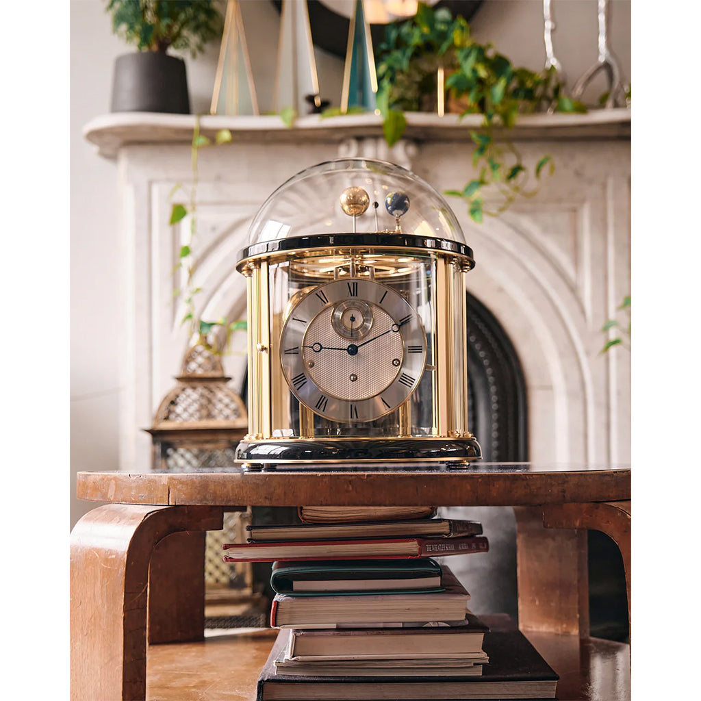 Hermle Tellurium Mantel Clock in Black/Brass in interior decor - Premier Clocks